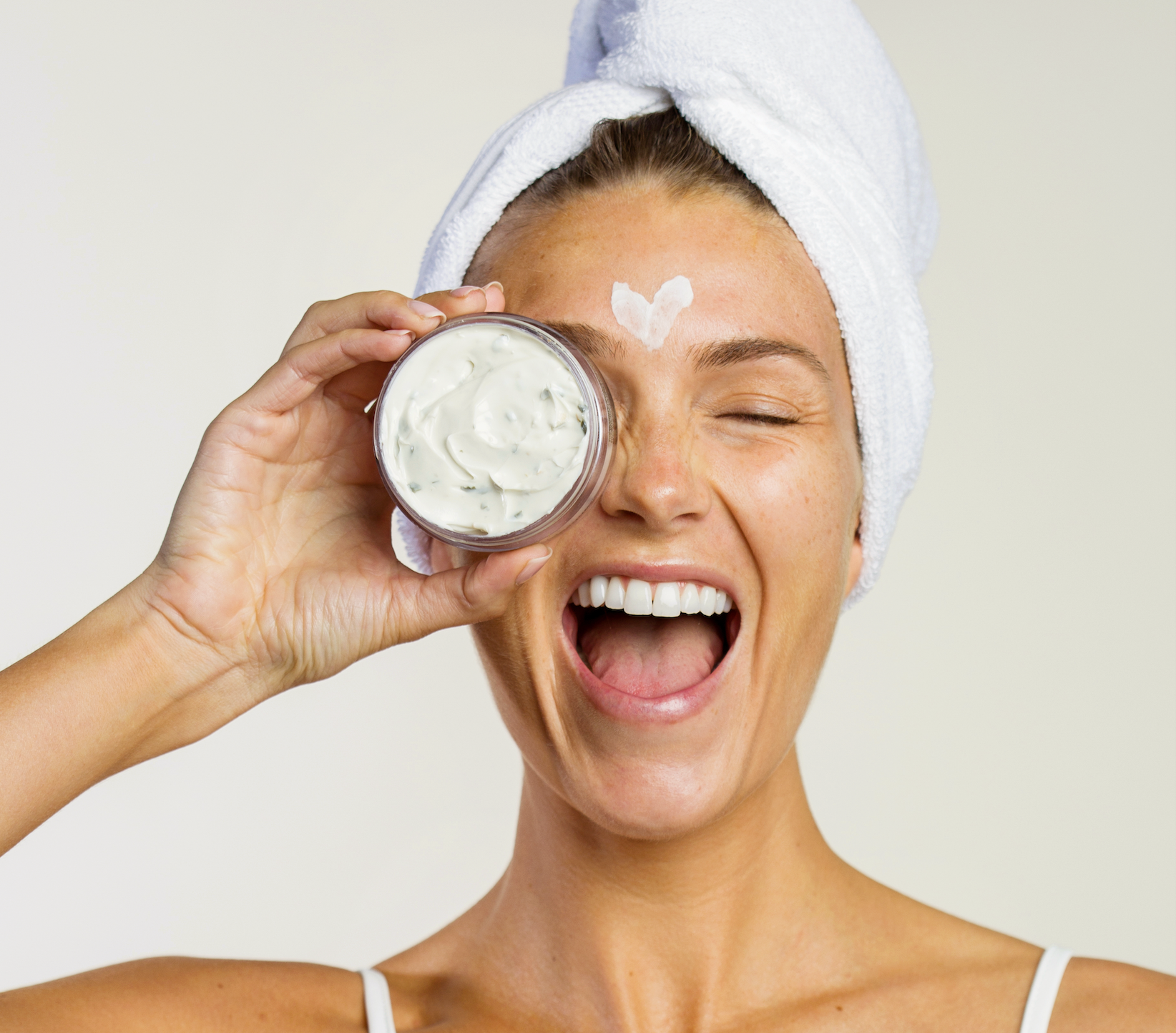 Woman holding an Eminence Organics Masque